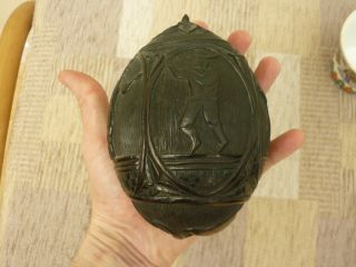 Antique Carved Coconut Money Box with Dutch Figures a Fish Head and Floral Ends 2