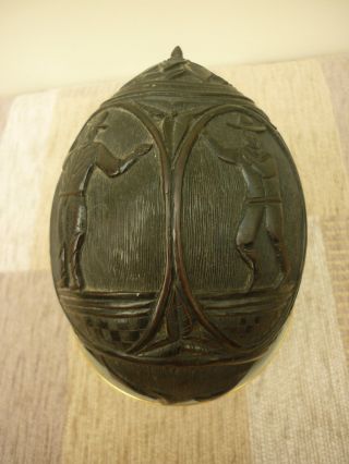 Antique Carved Coconut Money Box with Dutch Figures a Fish Head and Floral Ends 4