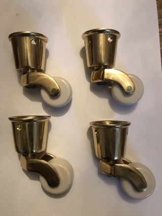 Set Of Four 1 3/8” Antique Style Brass And White Porcelain Socket Cups Castors