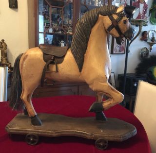 Vintage Handcarved Wood Horse On Base W/iron Wheels Leather Saddle Metal Stirrup