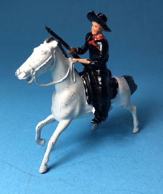 Vintage Britian Cowboy Dressed In Black On White Horse With Rifle