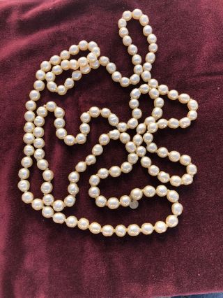 Vintage Chanel Faux Pearl Long 64” Strand With Goldtone Chanel Tab 1981
