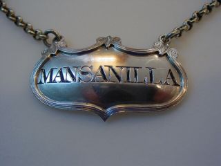 Unusual sterling silver decanter label incised for MANSANILLA,  a rare variant 8