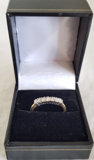 An 18ct White & Yellow Gold half Eternity Ring.  Set with Brilliant cut Diamonds 12