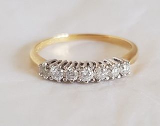 An 18ct White & Yellow Gold Half Eternity Ring.  Set With Brilliant Cut Diamonds