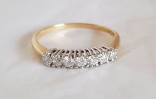 An 18ct White & Yellow Gold half Eternity Ring.  Set with Brilliant cut Diamonds 8