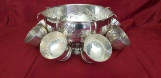 A Antique Silver Plated Punch Bowl & 6 Cups With Respoused Patterns.