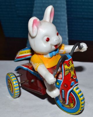 Vtg Tin Toy Wind Up Blow Mold Easter Bunny Rabbit Riding Bike Bell Rings,