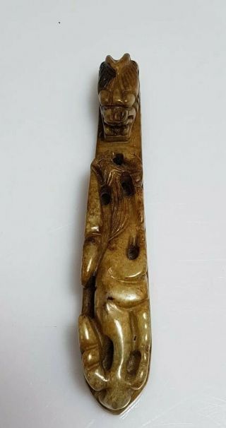 A Qing Dynasty Mottled Green Jade Dragon Head Belt Hook.