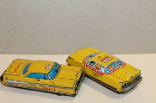 TWO VINTAGE TIN LITHO FRICTION POWERED PLYMOUTH YELLOW & CHECKER TAXI CABS 2