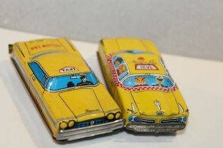 TWO VINTAGE TIN LITHO FRICTION POWERED PLYMOUTH YELLOW & CHECKER TAXI CABS 4