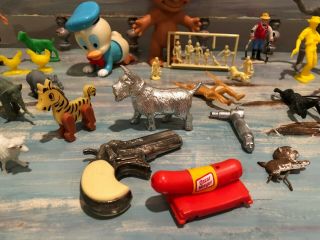 50,  vintage toys: Donald Duck,  troll,  model train people,  Oscar Mayer whistle. 2