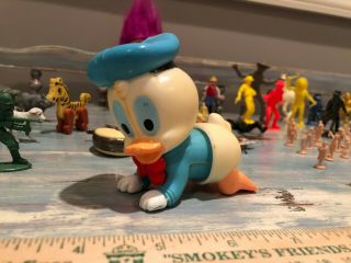 50,  vintage toys: Donald Duck,  troll,  model train people,  Oscar Mayer whistle. 7