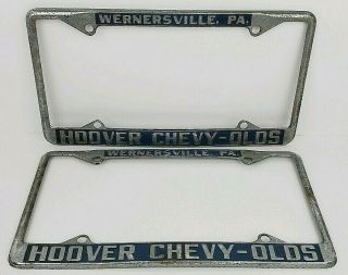 (2) Vintage Chevrolet Oldsmobile Hoover Car Dealer Metal License Plate Frames Pa