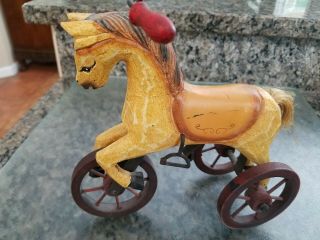 Vintage Wood Carved Horse On Three Wheels Metal Frame.