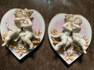 Antique Porcelain Putti Relief Wall Plaques,  2 Crossed Arrows Mark Made In Japan