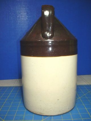 1 GALLON BROWN AND BEIGE STONEWARE JUG AND DISPLAY 2