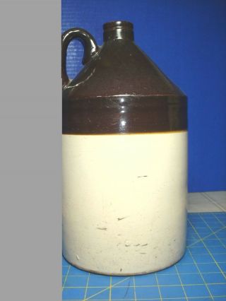 1 GALLON BROWN AND BEIGE STONEWARE JUG AND DISPLAY 3
