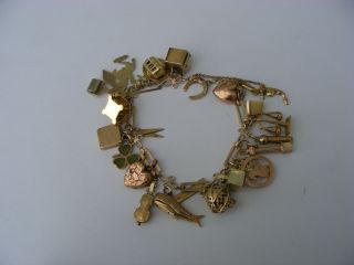 A Vintage 9ct Gold Charm Bracelet With 25 Charms,  Lock And Chain 38.  2 Gms