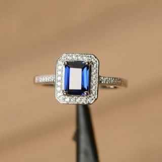1.  3ct Blue Sapphire Emerald Cut Diamond 14k White Gold Over Halo Engagement Ring