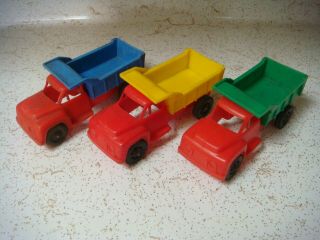 Three Vintage Plastic Toy Dump Trucks From The 1960s