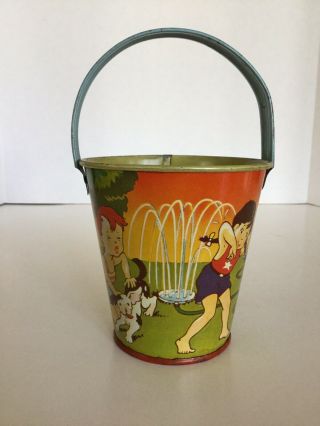 Vintage Us Metal Toy Co.  Tin Litho Sand Pail,  Children Playing With A Sprinkler