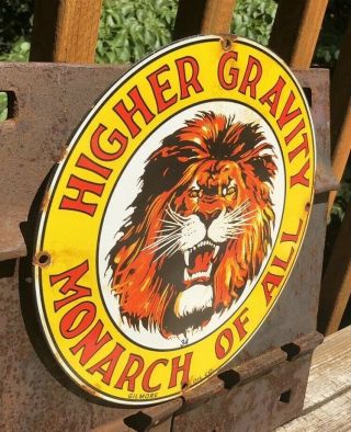 VINTAGE GILMORE HIGHER GRAVITY MONARCH OF ALL GASOLINE PORCELAIN SIGN 