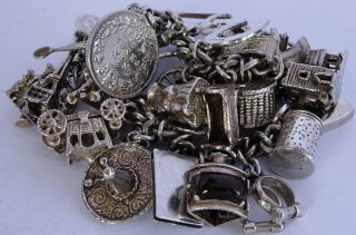 vintage heavy solid silver charm bracelet & 33 charms.  Rare,  open,  move 7