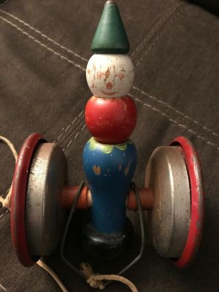 Vintage Metal and wood TOY ROLLING CLOWN Pull Toy with Bell inside 7 