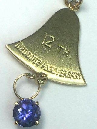 Lovely 14k Yellow Gold Anniversary 12th Bell With Natural Tanzanite Charm.  5.  0gm