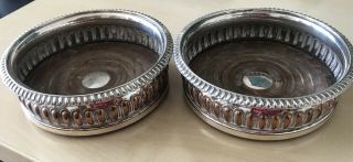 A Matching Antique Silver Plated Wine Bottle Coasters