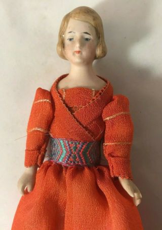 Antique German Bisque Girl with Orange Dress with Sash 3