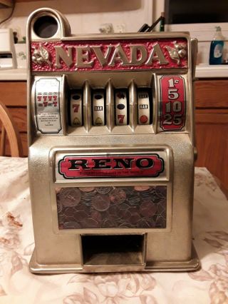 Two Vintage Coin Slot Machines,  One,  One.