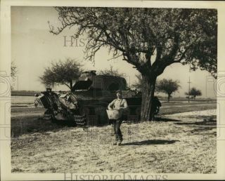 1946 Press Photo A Farmer Sows Spring Seeds Near A Wrecked Tank In Normandy