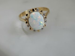 A 9 Ct Gold Cabochon Opal And Diamond Ring
