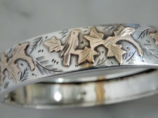 A Stunning Antique Silver And Gold Engraved Bangle And Safety Chain