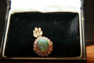 Vintage Pendant: Large Opal Surrounded By Diamonds.  18 Carat Gold Setting