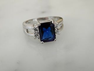 A Stunning 10 Ct Gold Emerald Cut 3.  00 Carat Blue And White Stone Ring