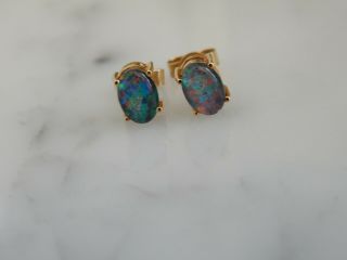 A Stunning 9 Ct Gold Oval Black Opal Earrings