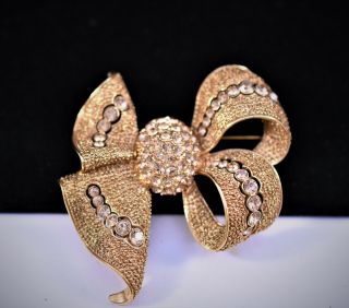 Vintage Joan Rivers Pinkish Crystals Textured Gold Tone Bow Brooch