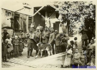 Port.  Photo: Neat Wehrmacht Troops W/ Accordians Play For Villagers On Street