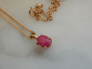 A Stunning 9 Ct Gold Oval Ruby Pendant And Chain