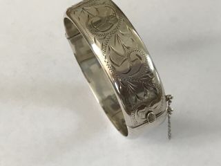 Vintage silver engraved bangle bracelet.  Width 3/4”.  Weight 27 grams 2