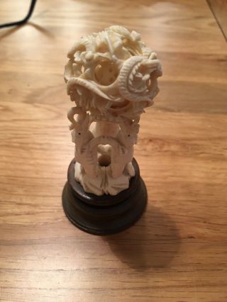 Vintage Chinese Hand Carved Puzzle Ball Sitting On Three Elephants On A Stand.