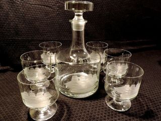 Vintage Toscany Decanter With 6 Footed Glasses Featuring An Etched Clipper Ship