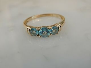 A Stunning 9 Ct Gold Blue Zircon Three Stone Ring