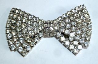 A Vintage 1950s Silver Tone Bow Brooch With Claw Set White Diamantes